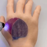 Watch this invisible tattoo appear under UV light